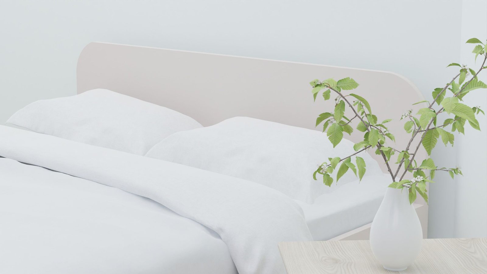 Chambre lumineuse avec linge de lit clair et plante